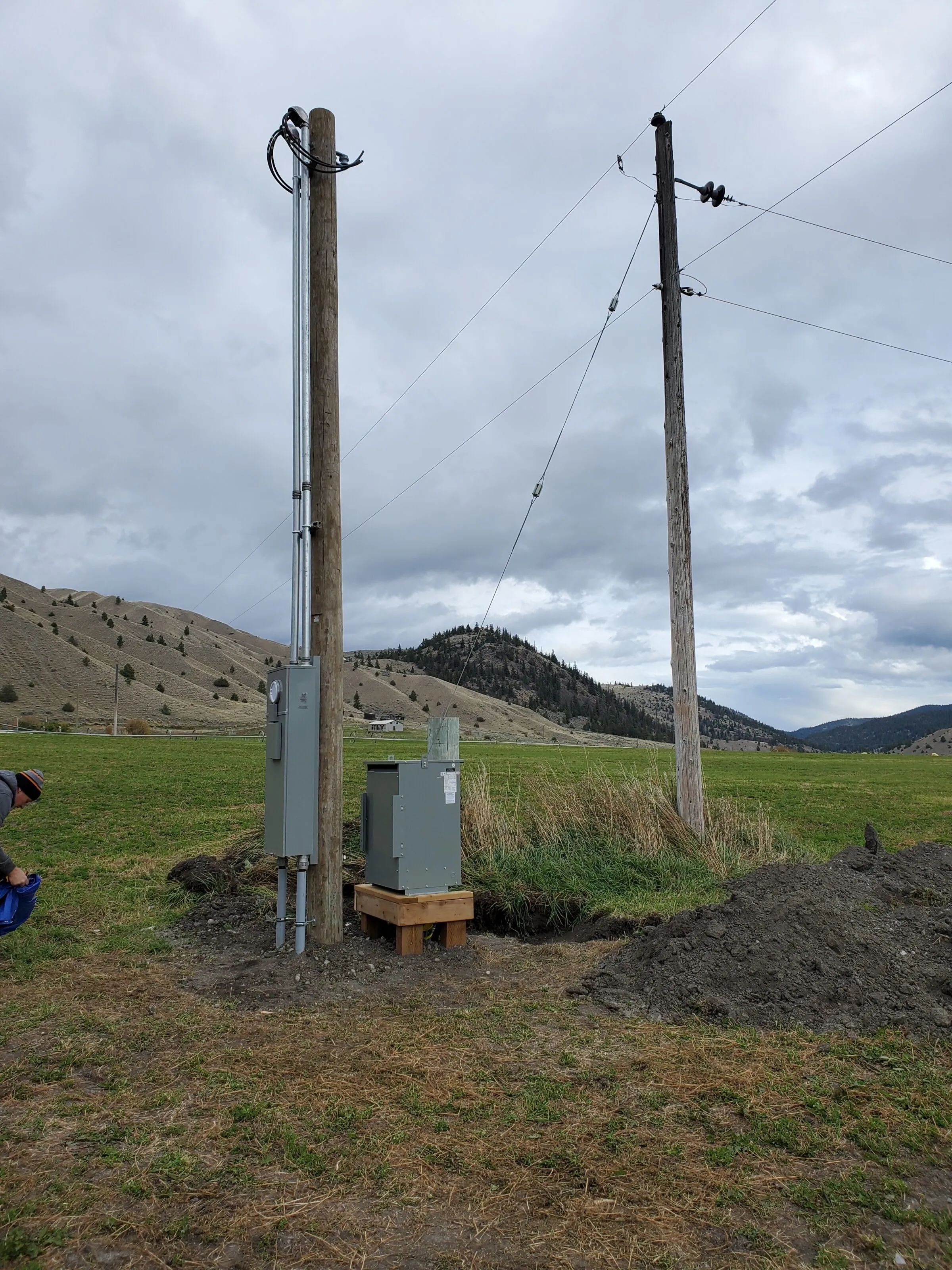 New pole-mounted metered service and transformer in a rural BC field