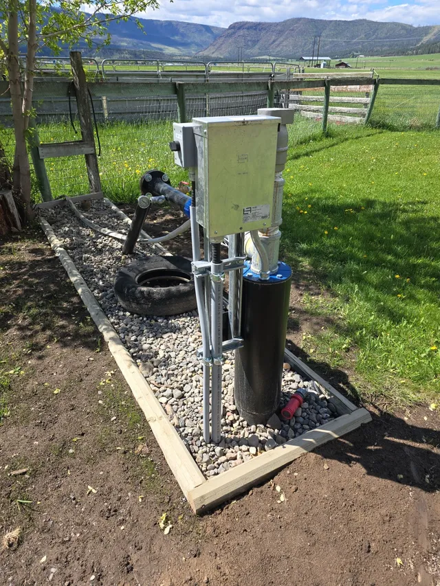 New metered service and control cabinet on a pole at a cleared acreage