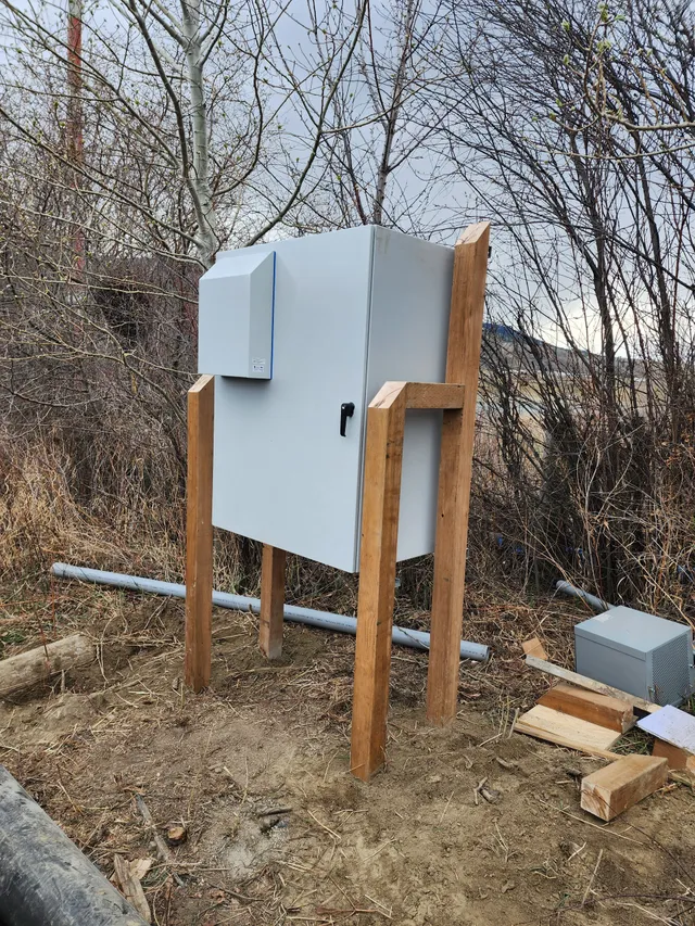 VFD, panelboard and starter enclosures wired on a wood-framed pump house wall