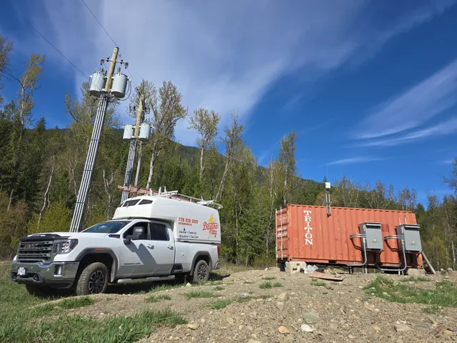 Dayton Power truck at the container electrical room, beneath the pole-mounted transformer banks