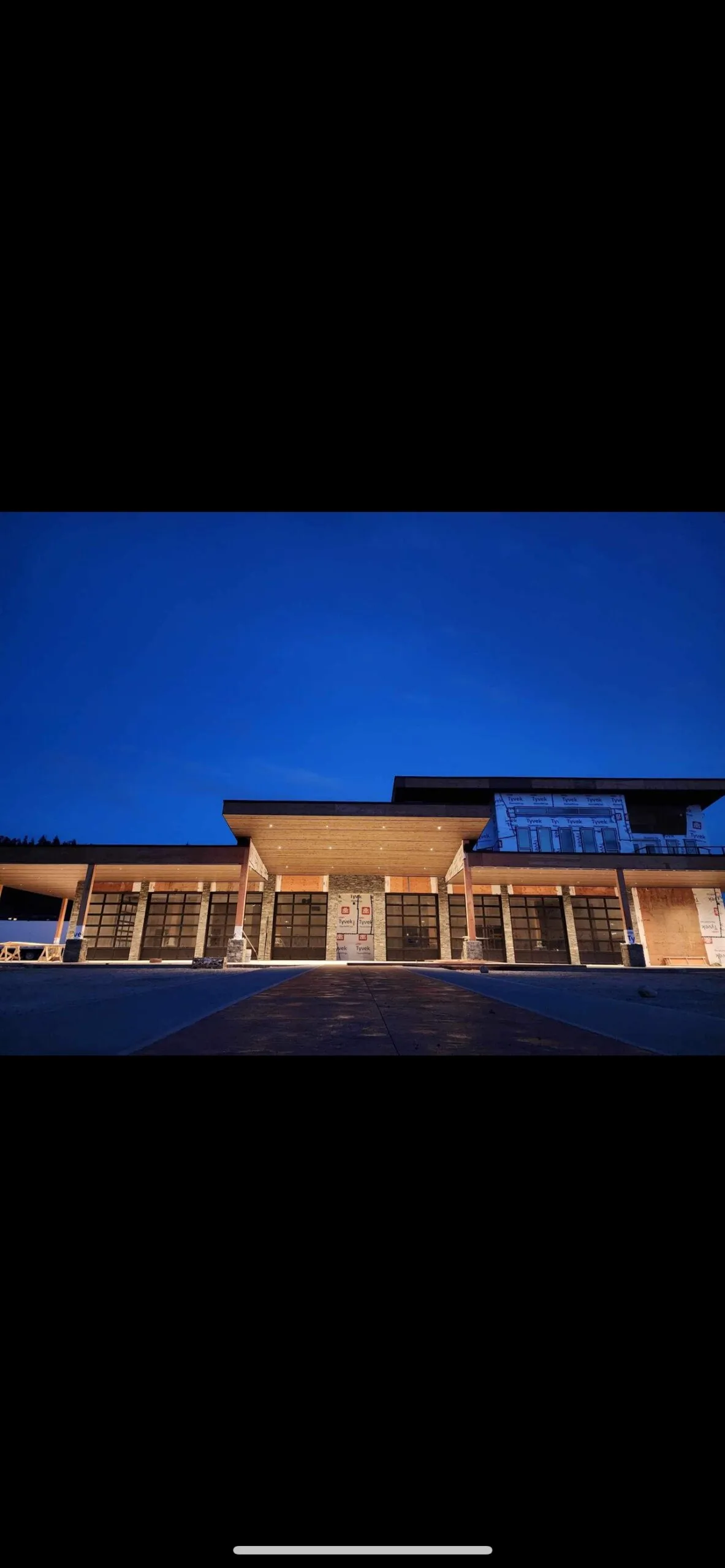 Commercial building exterior at dusk with new soffit and canopy lighting