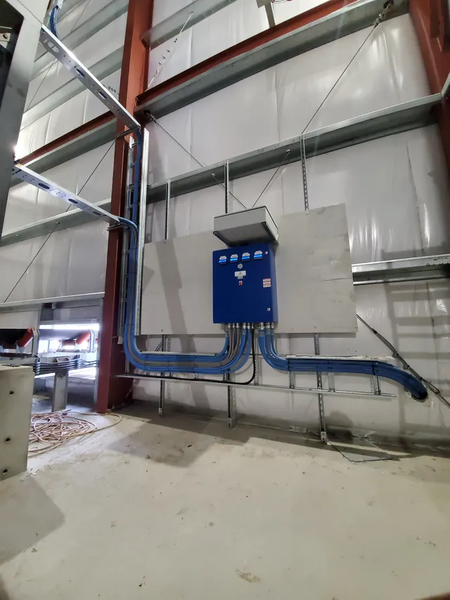 Control panel and conduit runs mounted high on the batch plant structure