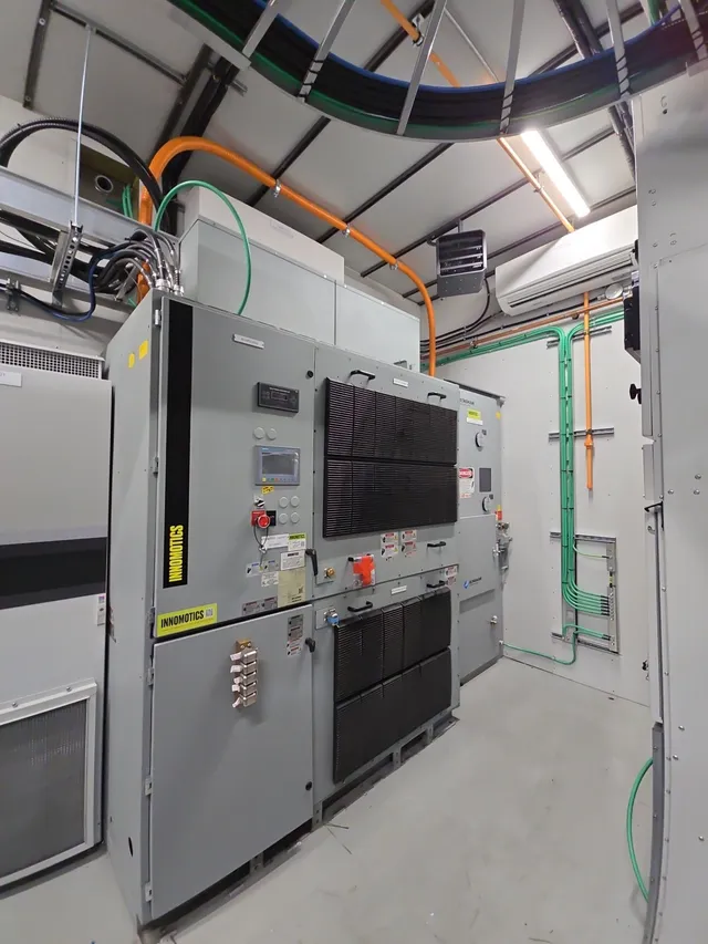 Medium-voltage VFD installed in the drive room with cooling and cable runs