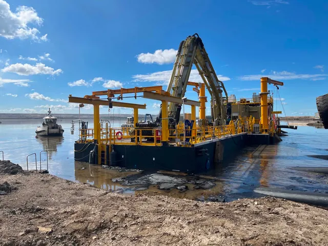 Suncor's tailings dredge unit on the water, carrying the completed E-House