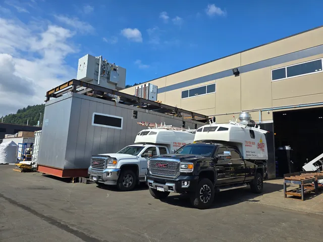 The modular E-House under construction in Chilliwack, with Dayton Power trucks on site