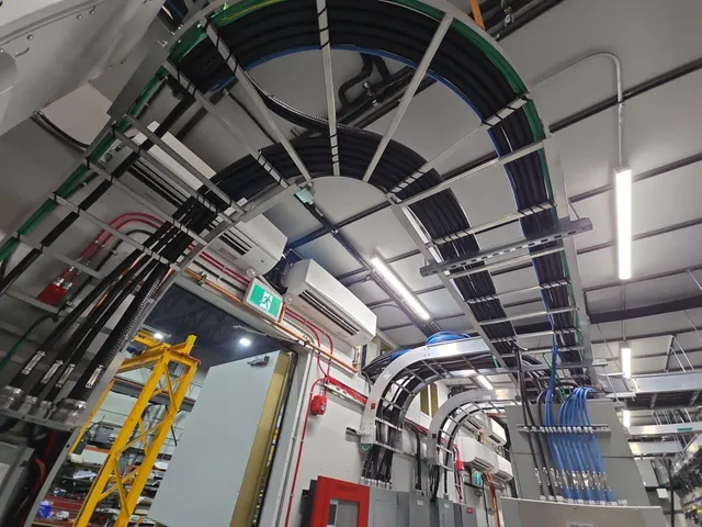 Radiused cable tray runs overhead inside the E-House