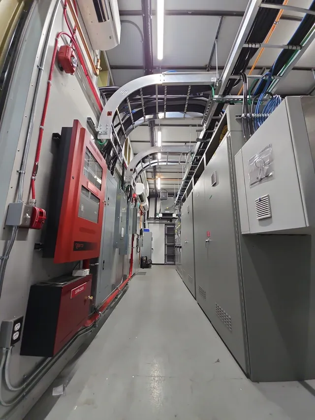 Corridor between the fire alarm wall and the MCC lineup inside the E-House